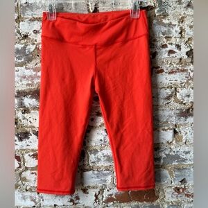Fabletics Women’s Cropped Capri Length Leggings in Red Orange